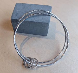 Student's handmade silver bangles in Cardiff jewellery making workshop