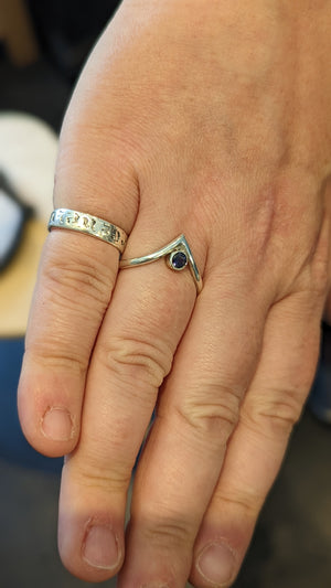 Student shows handmade silver and stone ring made in jewellery making workshop