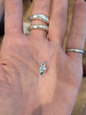 Student shows handcrafted silver acorn bead made in jewellery making workshop