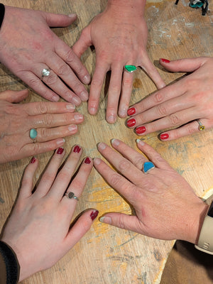 Students display their handmade se glass and stone rings made by hand in the silver ring jewellery making workshop
