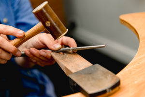 Student uses tools to size silver ring made in jewellery making workshop