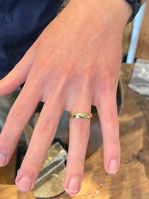 Husband to be shows handmade gold wedding band in private jewellery making course Cardiff