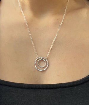 Student wears handmade silver necklace made in jewellery making workshop course