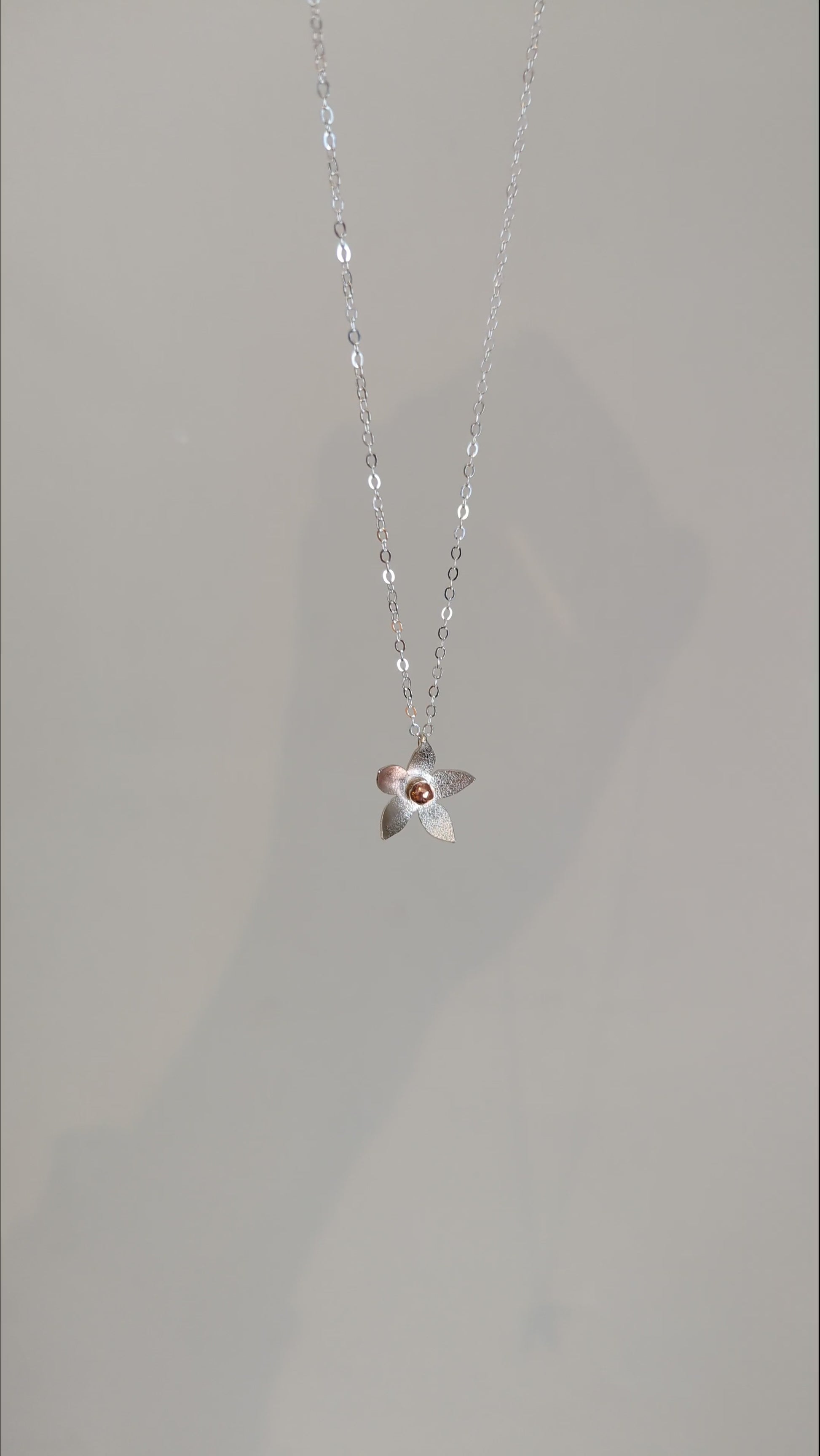 Example of handcrafted silver flower pendent necklace made in jewellery making workshop
