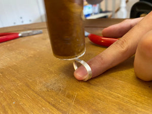 Silver wedding band being shaped by hand in private wedding band jewellery making course Cardiff