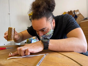 Student hand shapes wedding band in private jewellery making course in Cardiff workshop