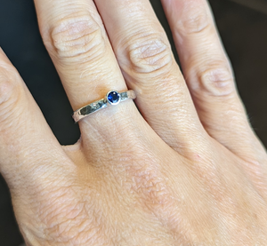 Student shows handmade silver and stone ring made in jewellery making workshop
