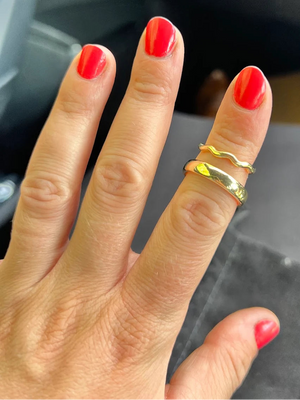 Bride to be shows handmade wedding bands created in private jewellery making workshop Cardiff
