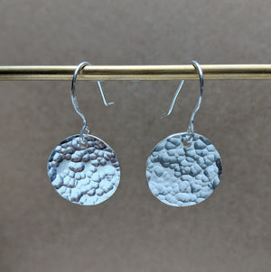 Examples of handmade silver earrings in jewellery making workshop