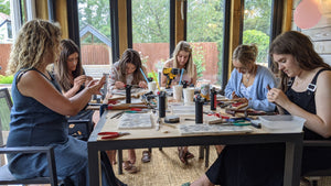 Private group of students concentrating on making their unique silver jewellery in workshop