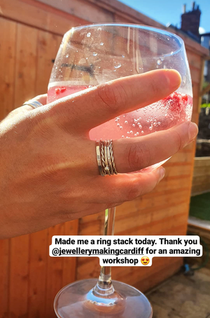 Student shows handcrafted silver rings made in jewellery making workshop