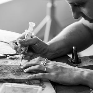 Student handcrafting silver stack ring in jewellery workshop