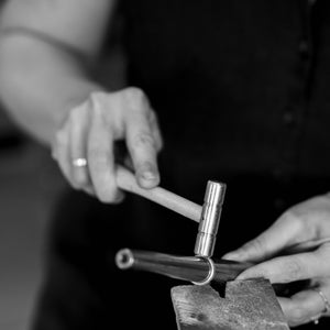 Silver stack rings being shaped and sized by hand in jewellery making workshop
