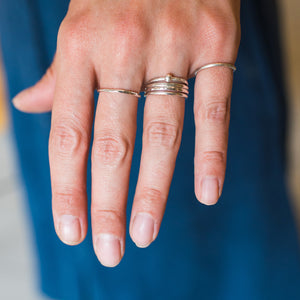 Student wears their handmade silver stacking rings made in jewellery making workshop