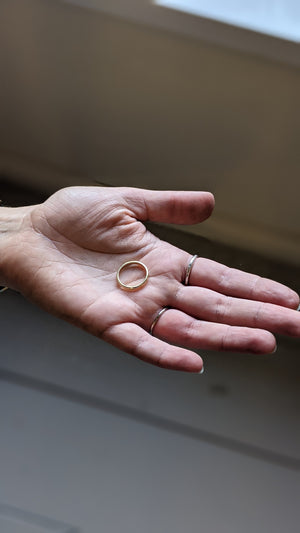 Student shows handmade wedding ring in private jewellery workshop